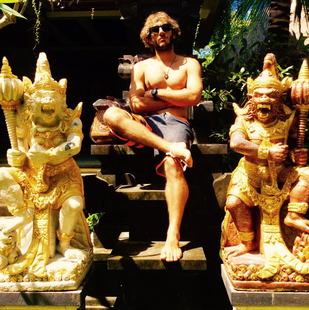 myself sitting between two statues in Bali